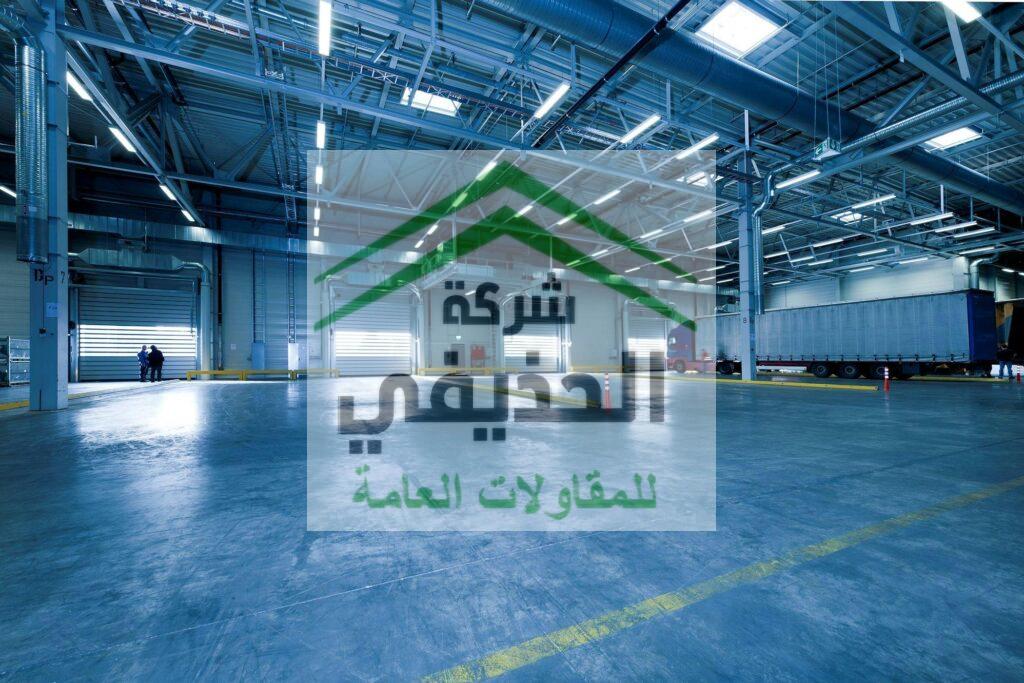 Large warehouse interior with docked truck, ideal for logistics and warehousing.